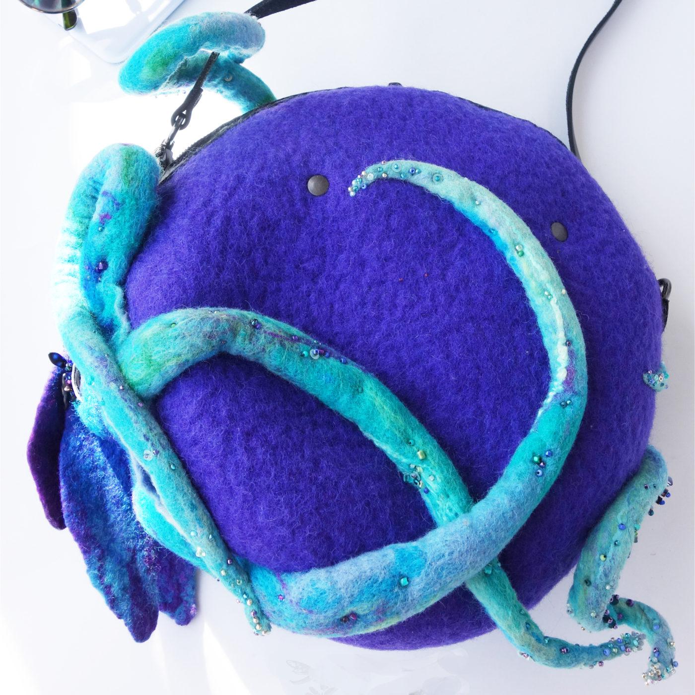 Violet circle bag with blue tentacles from the back